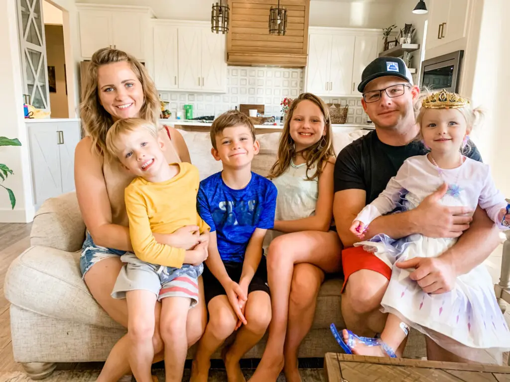 A photo of the Burns family sitting on the coach.
