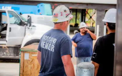 Construction crew wearing PPE as they stand outside.