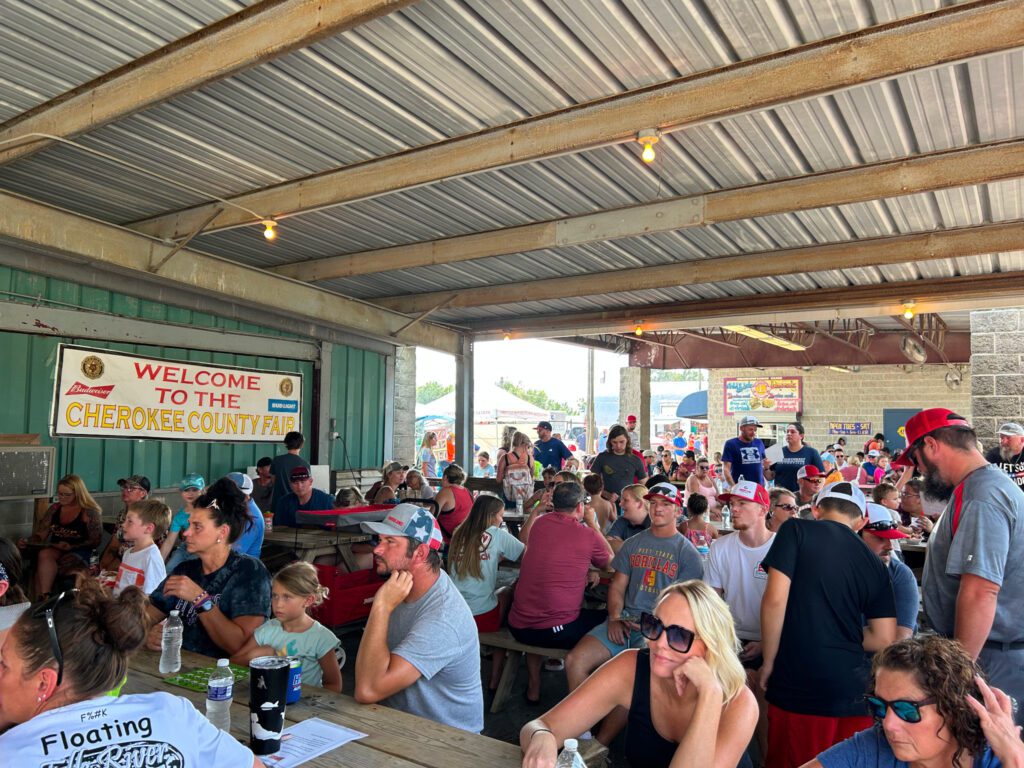 A crowd of people sitting at tables.