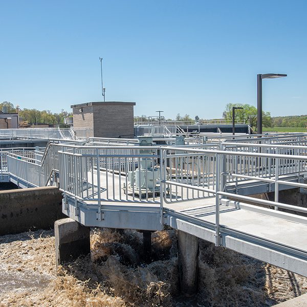 A water treatment plant with metal railings and a walkway.