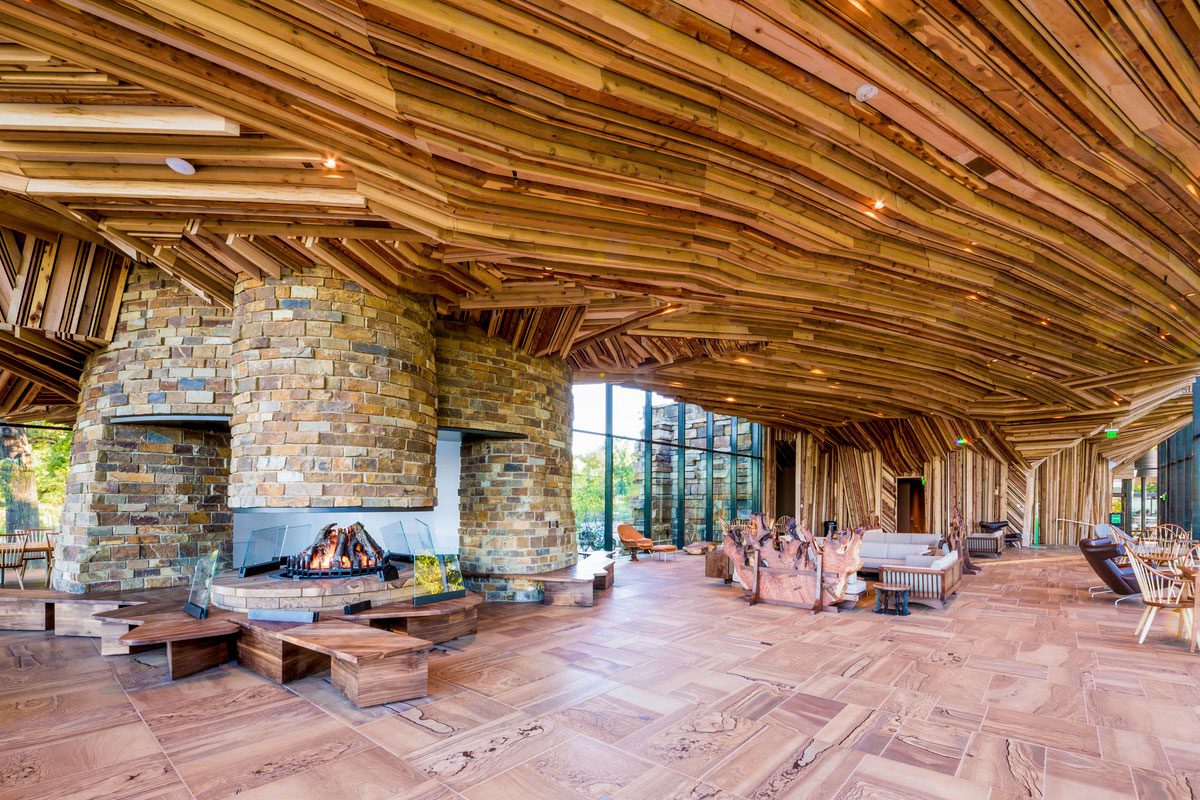 Interior of a large open room with artistic use of wood for ceiling, walls and floor.