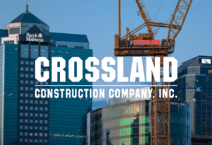 A city skyline with skyscrapers and a construction crane, featuring the Crossland Construction Company, Inc. logo in bold white text centered over the image, highlighting the crossland commitment to building excellence.