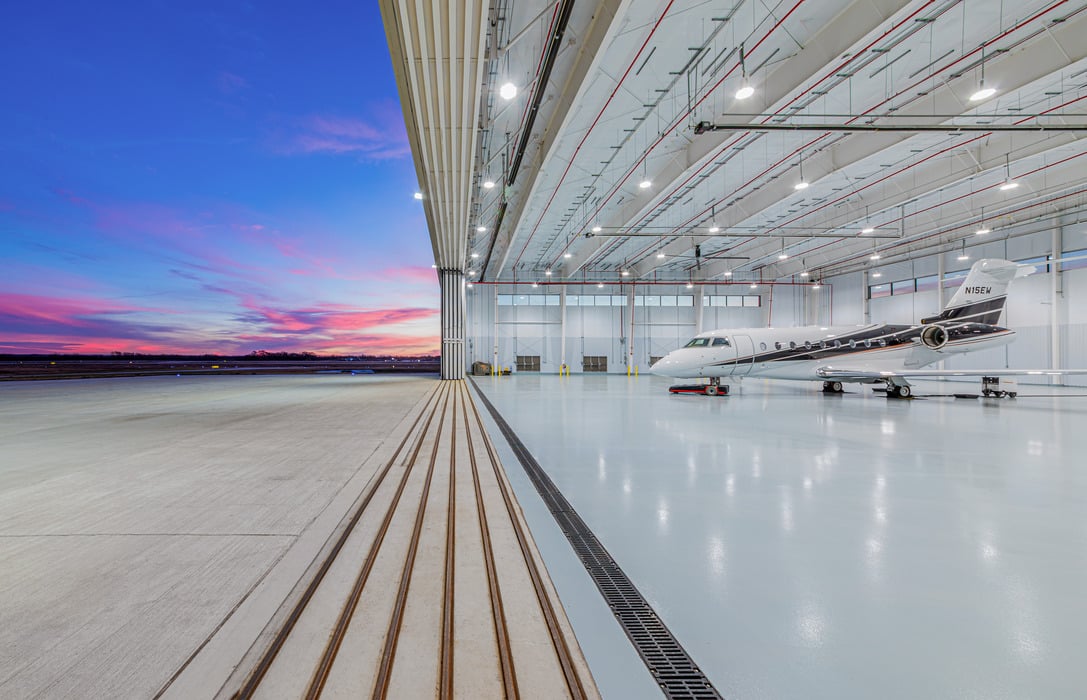 Aircraft hangar interior with a business jet