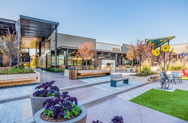 Landscaped outdoor plaza with seating and public art